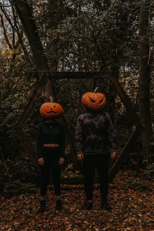 People Standing with Pumpkins