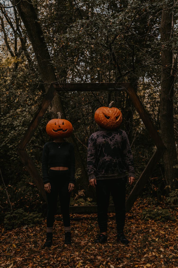 People Standing With Pumpkins