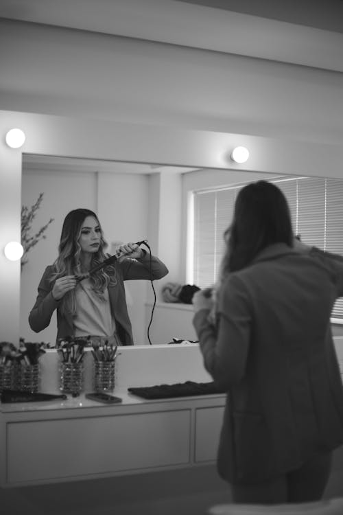 Free Woman Looking at a Vanity Mirror Stock Photo