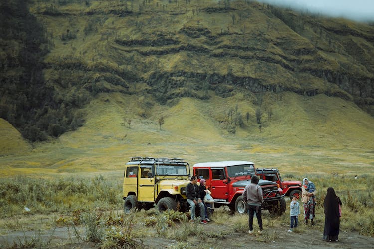 People With Jeeps Near Hill