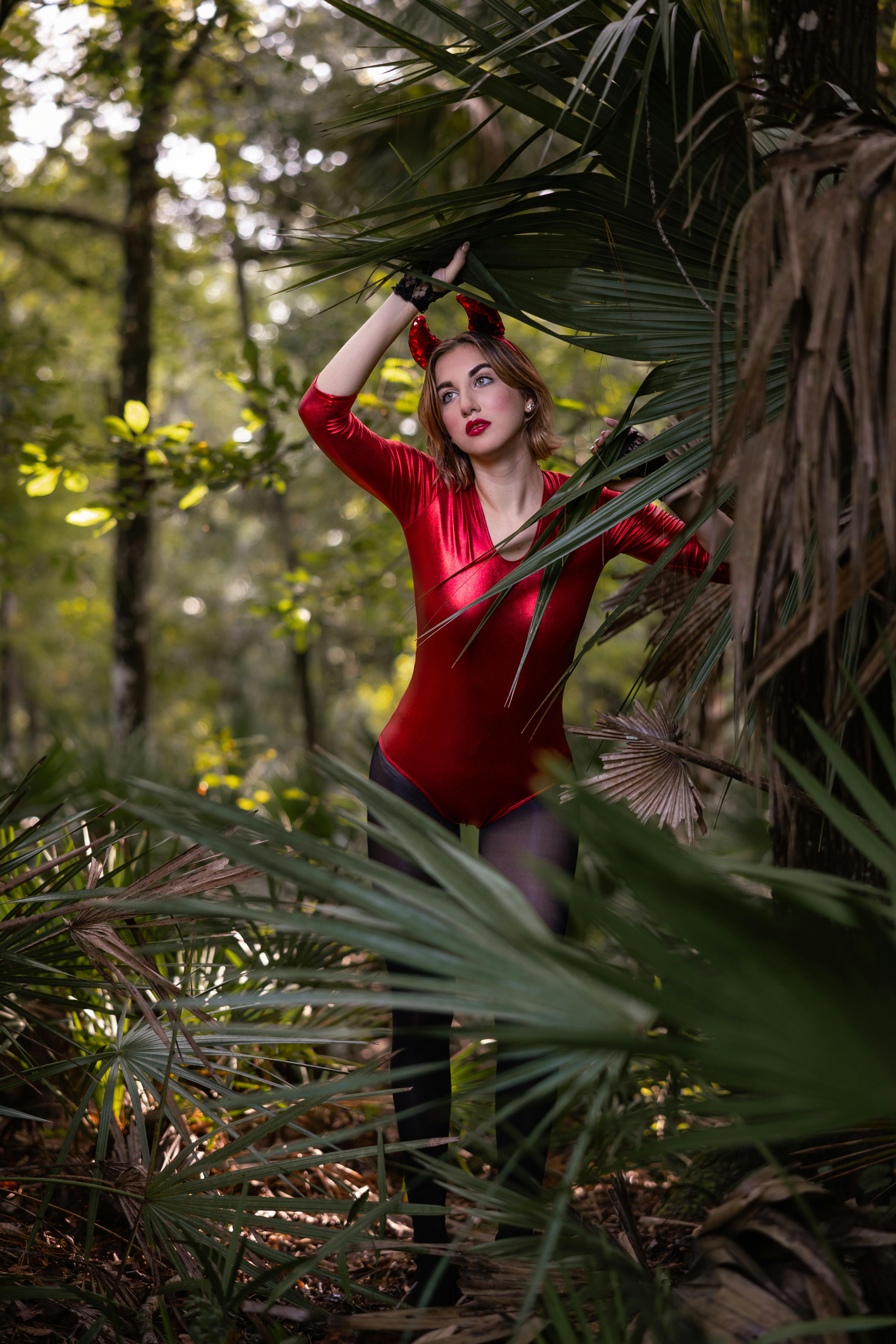 woman in a devil costume posing in the forest