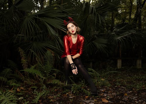 Woman in a Devil Costume Posing in the Forest 