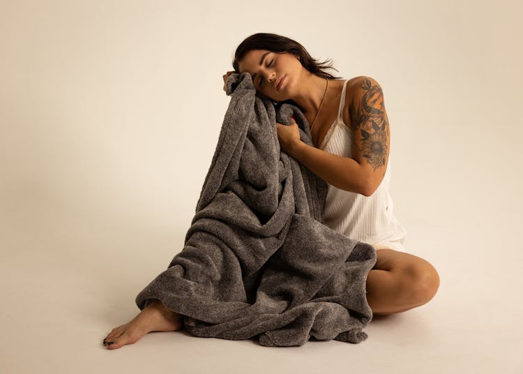 Woman In Sleepwear With A Cosy Blanket 