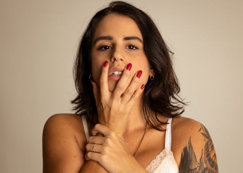 Close Up Photo of Woman with Her Hand on Her Face