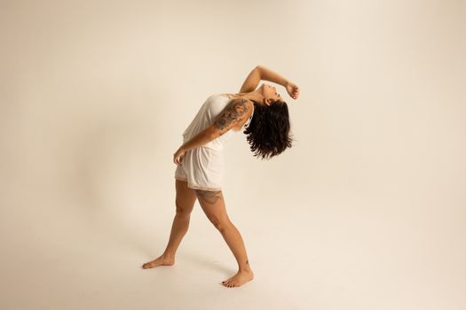 Woman in White Dress Standing and Raising Her Both Hands