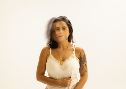 A Tattooed Woman Wearing a White Spaghetti Strap