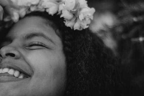 Grayscale Photo of a Girl with Flowers on Head