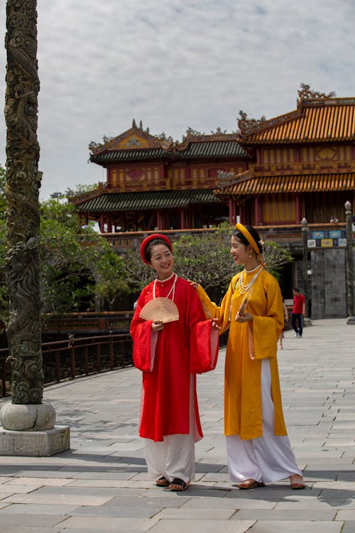Women Wearing Traditional Clothing in front of Temple