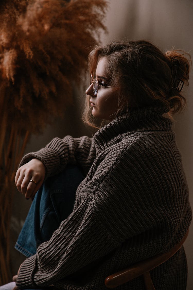 Woman Wearing A Sweater And Eyeglasses 