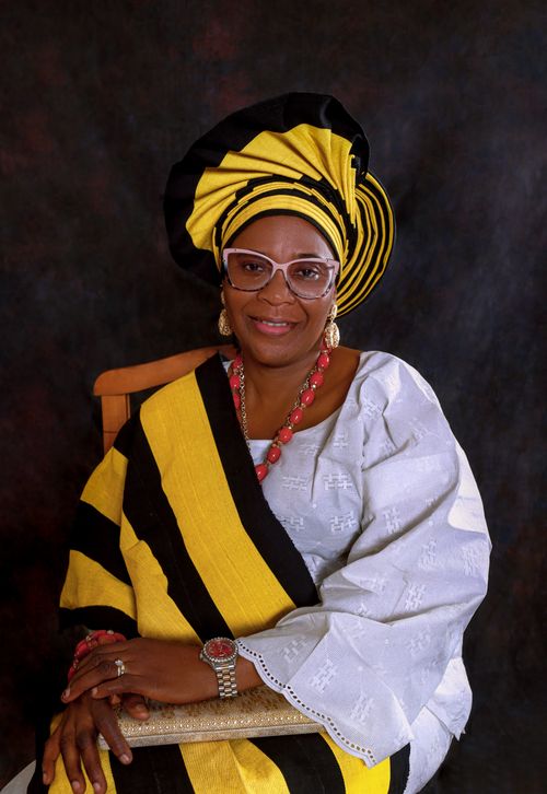 Free Portrait of an African woman wearing a yellow and black headwrap and eyeglasses. Stock Photo
