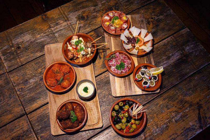 A shared table of small plates in a restaurant &mdash; photo by Bas Linders on Pexels