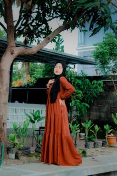 Young woman posing in a long dress outdoors in Kota Tasikmalaya, Indonesia.