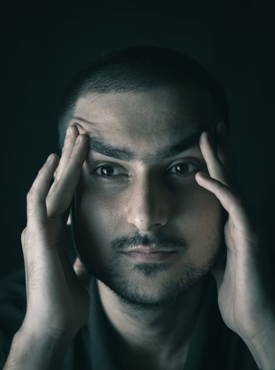 A Man Holding his Face · Free Stock Photo