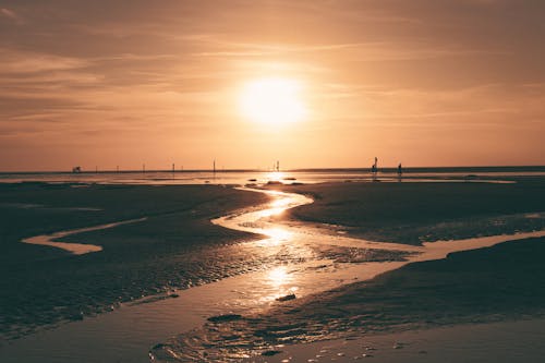 Sunset Over Wet Beach Exposed by Low Tide