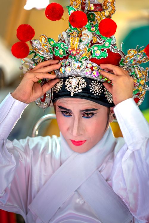 Free A person in elaborate traditional costume preparing for a cultural festival. Stock Photo