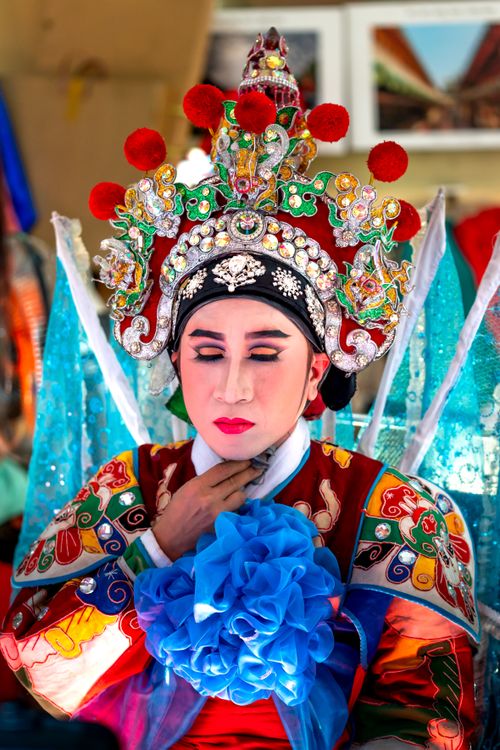 Free Person in elaborate traditional costume and headdress, eyes closed, embodying cultural heritage. Stock Photo