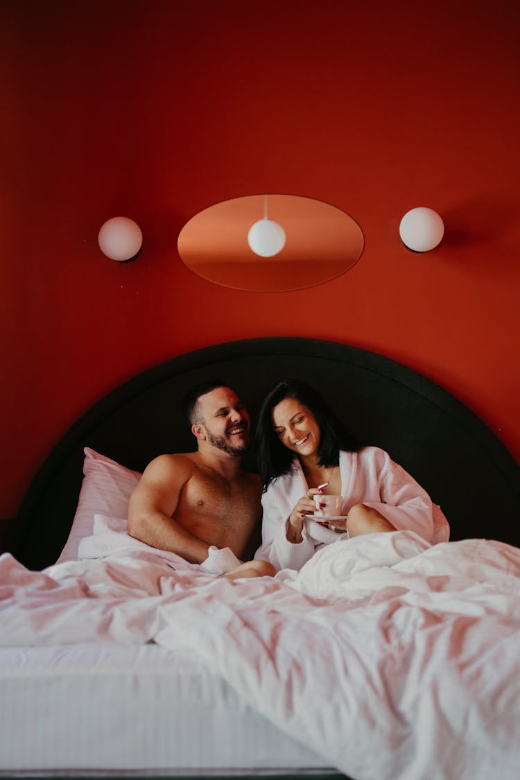 A Couple Laughing In Bed