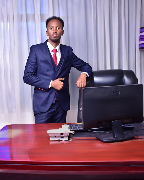 A Man Wearing Suit and Tie Standing in the Office