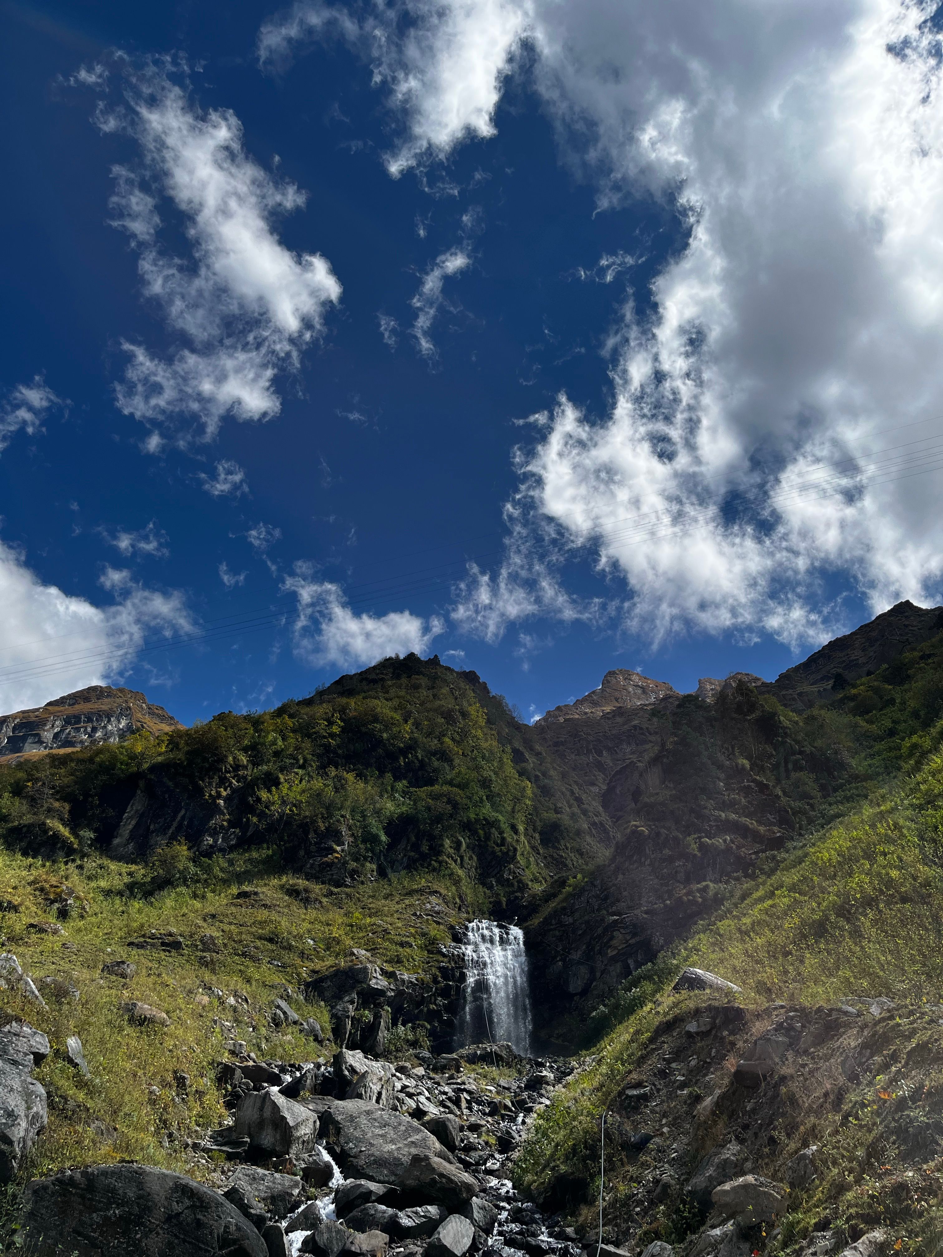 Water Falling on Big Rocks Under Cloudy Sky · Free Stock Photo