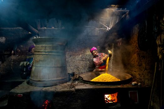 Women Cooking in a Dark Cellar Using a Large Traditional Oven