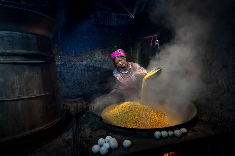 Woman Cooking In A Large Wok 