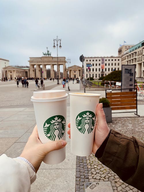 People Holding Starbucks Beverages