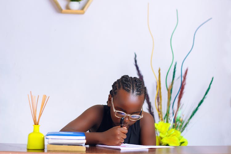 A Young Girl Studying At Home