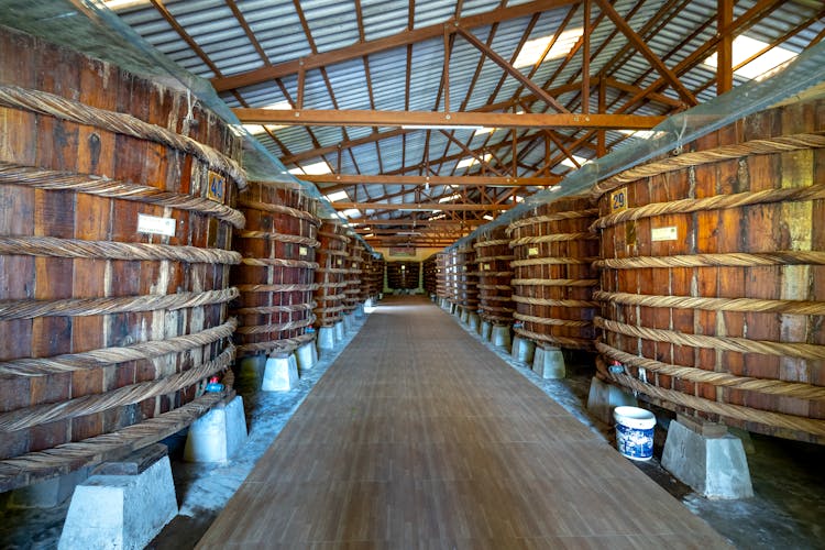 Wooden Barrels In A Storage, And Roof Construction