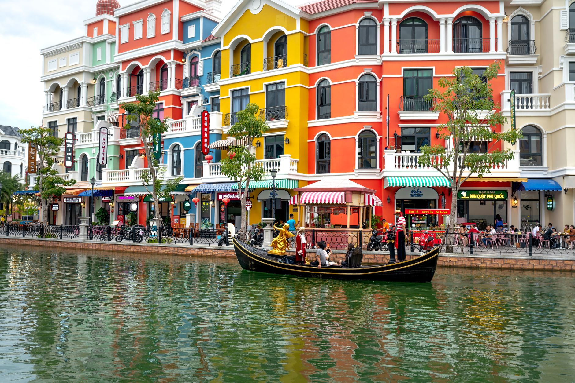 Vibrant canal scene with gondola and colorful buildings at Grand World Phu Quoc.