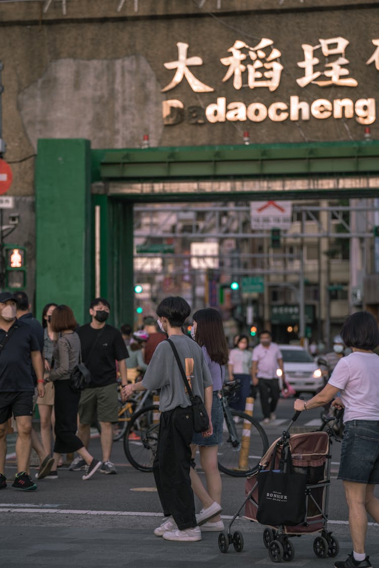 People Wearing Face Masks While Walking On The Street