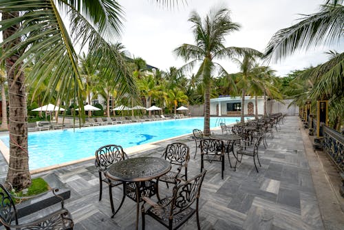 Metal Tables and Chairs Near Swimming Pool