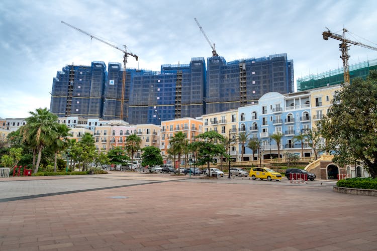 Buildings Under Construction Behind Modern Apartment Houses