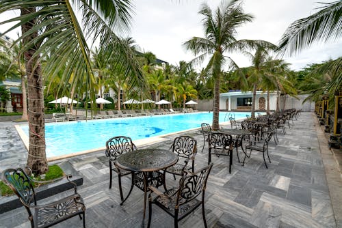 Tables and Chairs Near Swimming Pool