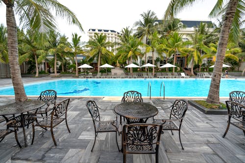 Chairs and Tables on the Poolside of a Resort