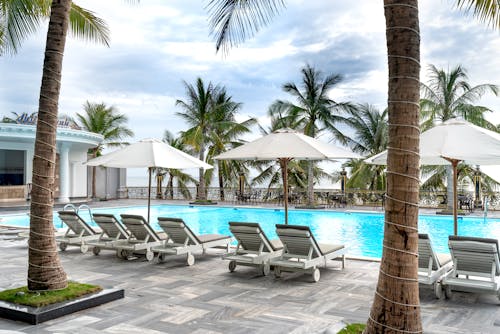 White Outdoor Lounge Chair on Poolside of a Resort