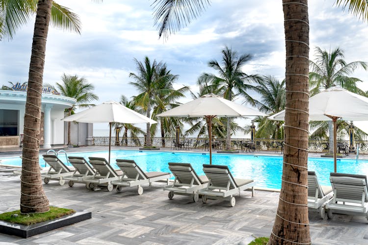 White Outdoor Lounge Chair On Poolside Of A Resort