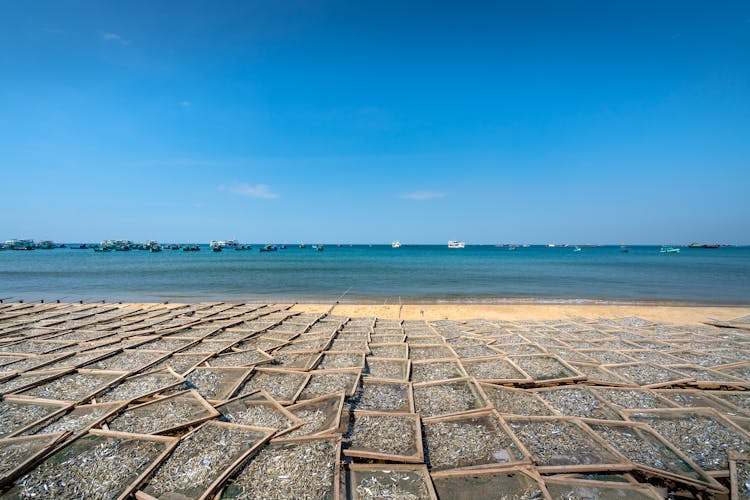 Boxes On Beach On Sea Shore