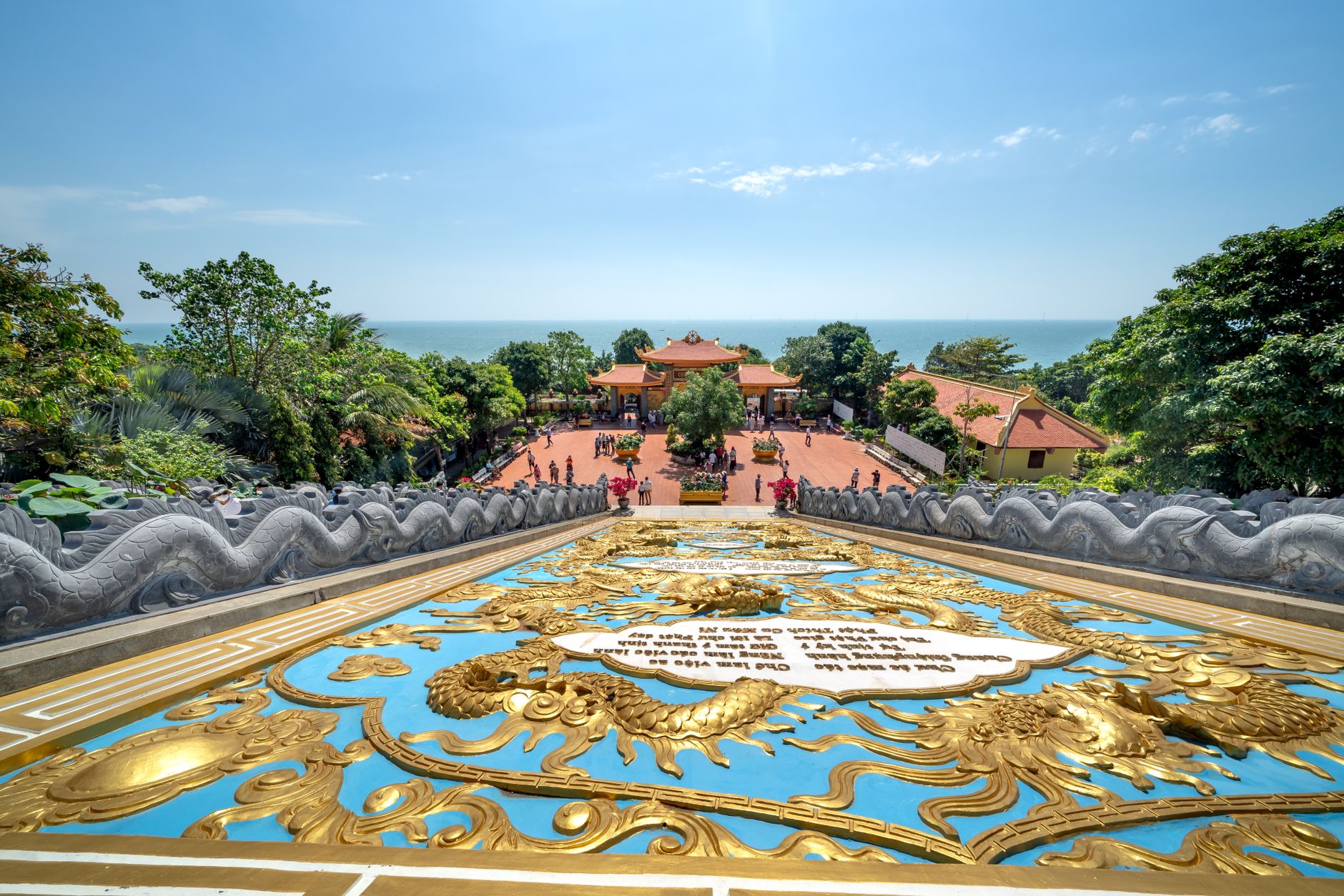 Breathtaking aerial of Ho Quoc Pagoda in Phu Quoc, surrounded by lush nature and sea.