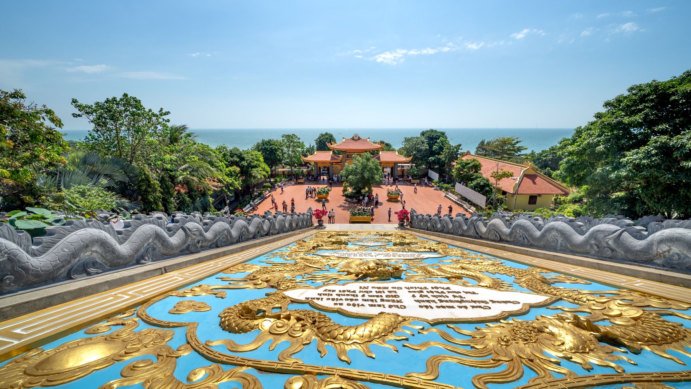 Breathtaking aerial of Ho Quoc Pagoda in Phu Quoc, surrounded by lush nature and sea.