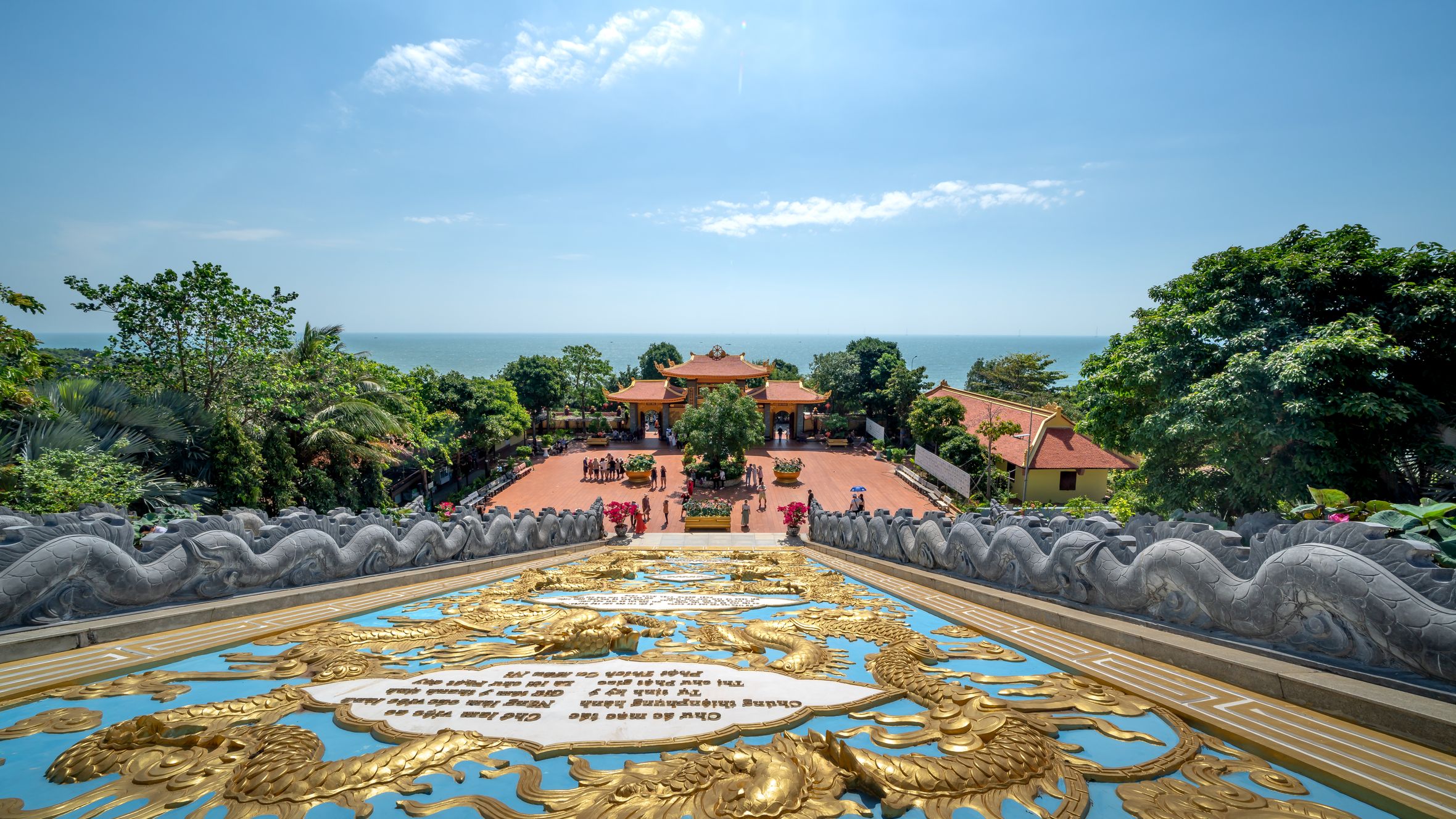 A panoramic view of Ho Quoc Pagoda in Phu Quoc, Vietnam, overlooking the ocean on a sunny day.