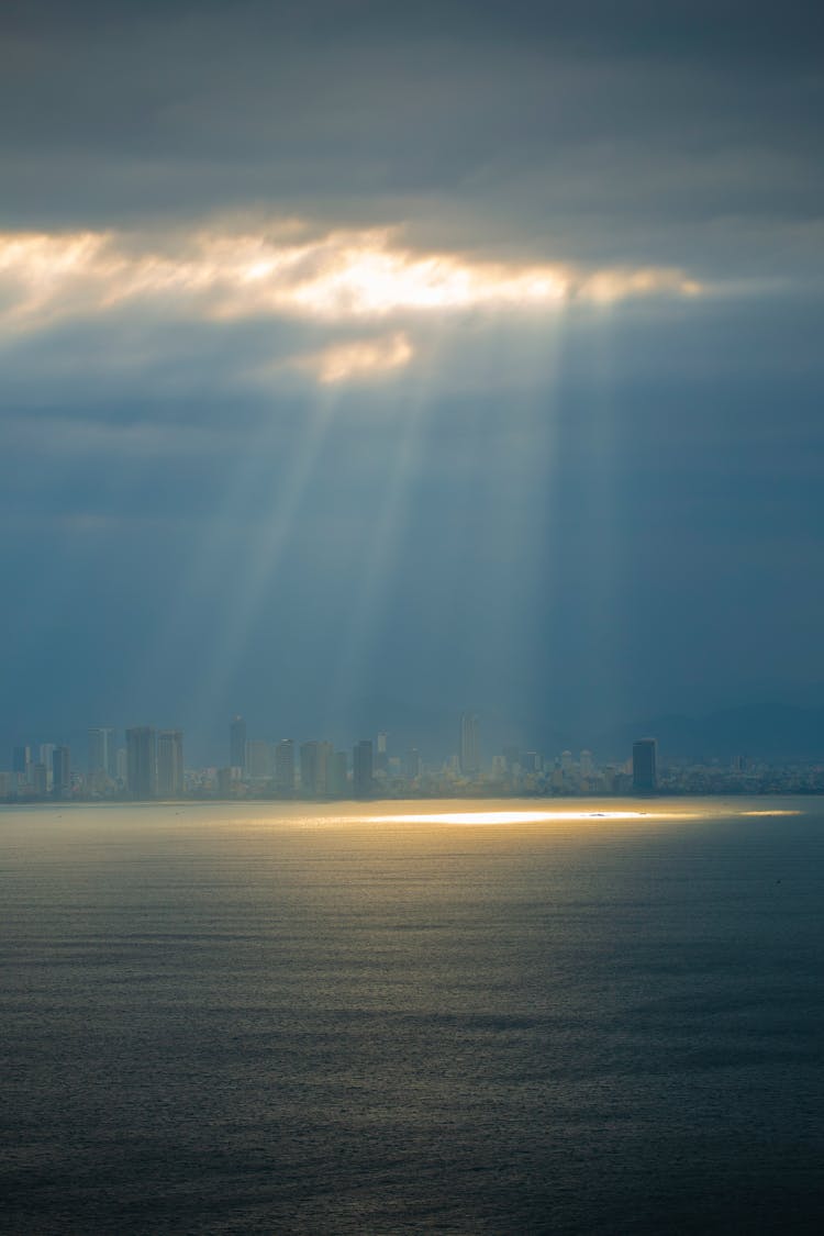 Sun Shining Through Clouds Onto Sea Surface