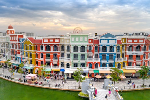 Vibrant resort scene at Grand World Phu Quoc with colorful facades and people walking by the water.