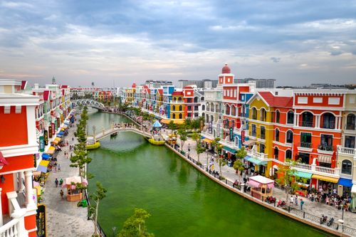 Free A vibrant canal promenade lined with colorful buildings in Phu Quoc, Vietnam, capturing a lively tourism spot. Stock Photo