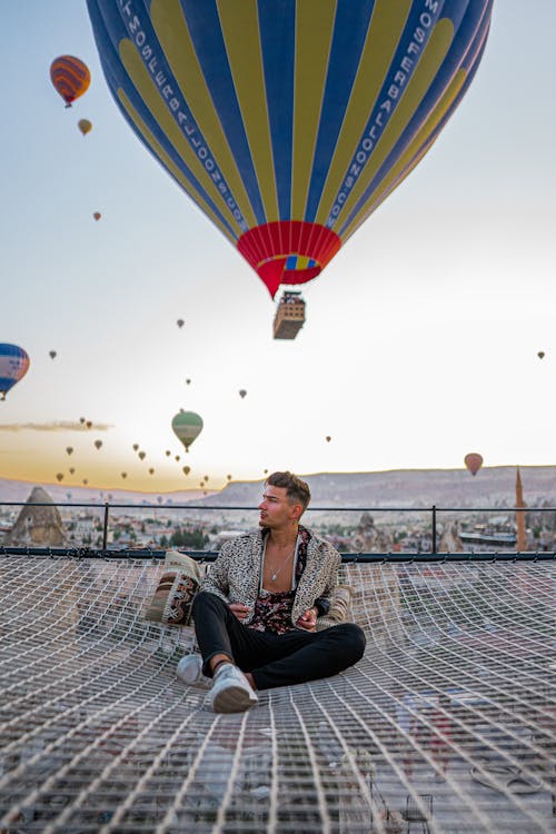 Balloons Over a Man on a Roof 