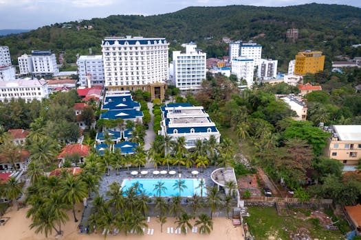 Aerial shot of a luxury resort with pool and palm trees in Phu Quoc, Vietnam.
