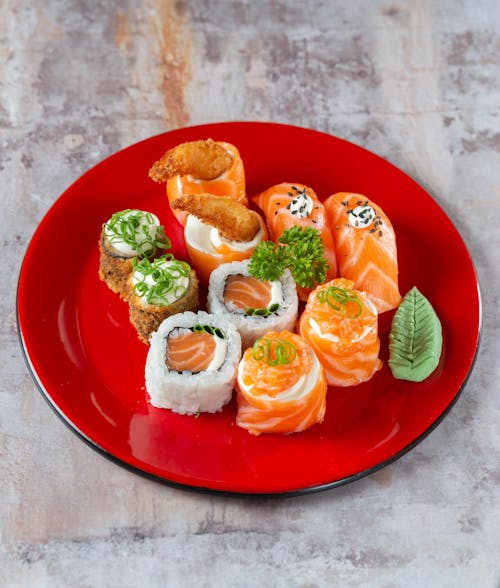 Close-Up Photo of Assorted Sushi on Red Plate