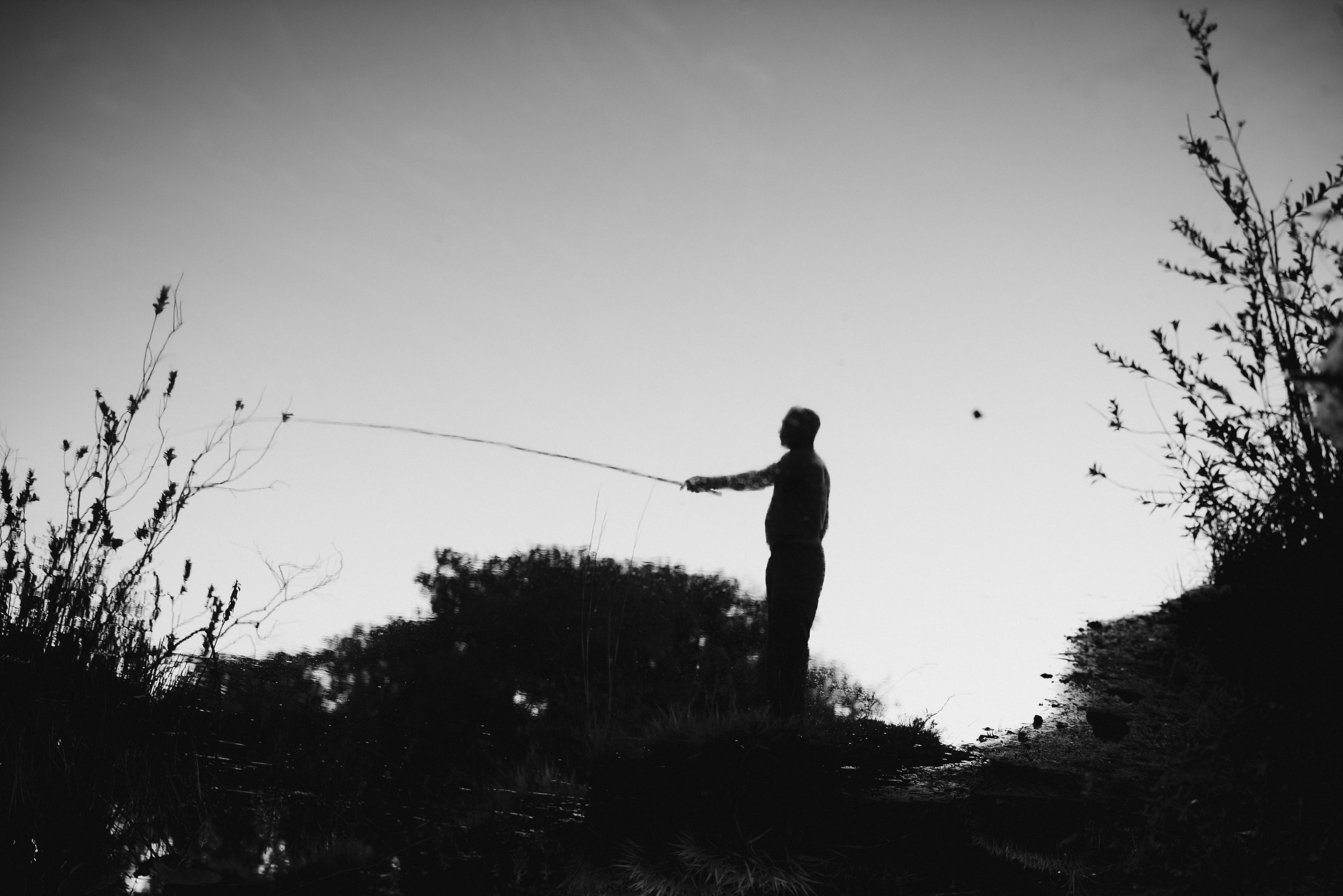 Silhouette of Man on Bank Fishing · Free Stock Photo