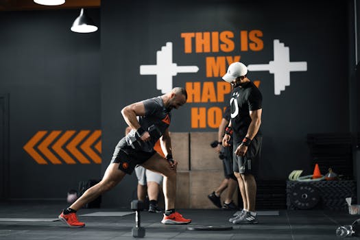 Two men working out with dumbbells in a Bahrain gym, demonstrating strength and fitness.