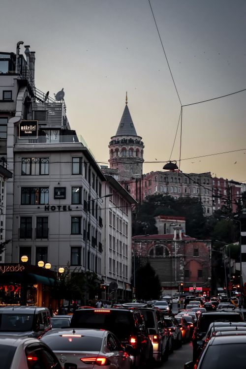 Free Evening traffic in Istanbul with a view of the iconic Galata Tower surrounded by city buildings. Stock Photo