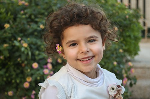 Portrait of a Little Girl with Flowers in her Hair 